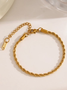 Detail of gold twisted rope chain bracelet featuring lobster clasp and extension link