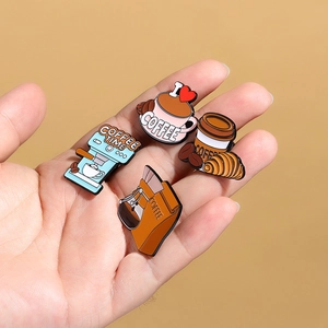 Set of 4 coffee themed enamel pins including coffee machine and cup held in hand
