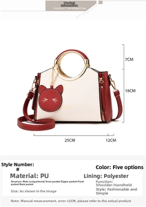 Detail view of red and white PU leather handbag with cat charm and size dimensions