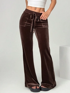 Detail of brown velvet flare pants showing the soft fabric texture and drawstring waist