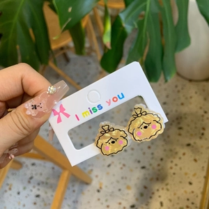 Cute cream puppy cartoon ear studs in acrylic material on 'I miss you' display card