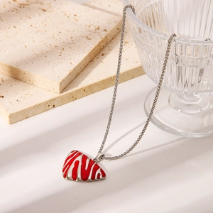 Polished stainless steel octopus cross necklace with red zebra pattern pendant on stone