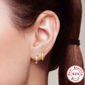 Three-piece set of S925 sterling silver star and heart earrings on a female model