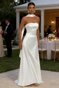 Detail of white satin strapless gown showing the sleek waistline at an outdoor dinner