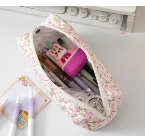 Spacious floral quilted pencil case showing large capacity for pens and stationery