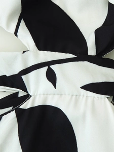 Detail shot of black and white leaf print fabric showing seams and stitching quality
