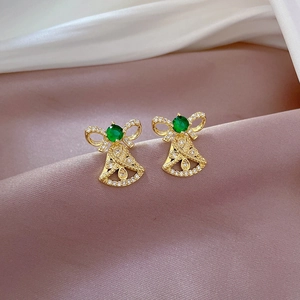 Close-up of gold bow earring with green gemstone and sparkling zircon micro-pave