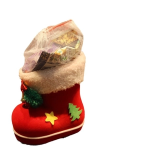 Red Christmas boot gift bag with plush trim, green tree applique, and golden bell detail