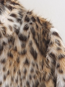 Close-up macro view of high-quality leopard print faux fur texture with long soft fibers