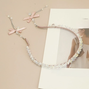 Close-up of pink iridescent beaded headband with silk bows and long tassel chains