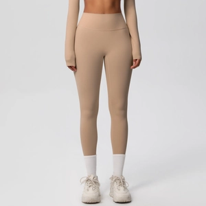Detail of high-waisted seamless beige yoga leggings with tummy control wide waistband