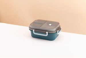 Deep blue double-layer lunch box with divided compartments and a grey transparent lid