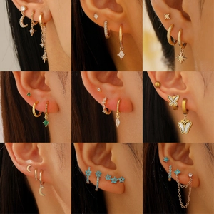 Elegant gold celestial earring set with star and moon charms featuring colorful zircons