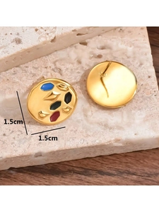 Macro detail of 1.5cm vintage gold geometric enamel earrings on stone background