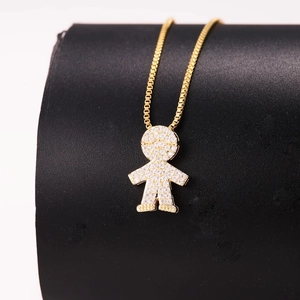 Macro detail of gold-plated boy pendant necklace with sparkling cubic zirconia pavé