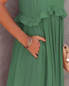 Detail of green tiered dress showing ruffled chest design and practical side pockets