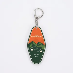 Detail of a retro hotel tag acrylic keychain with an outdoor camping tent design