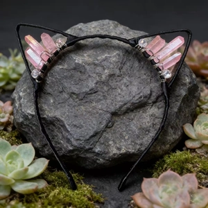 Detail of cat ear headband with pink crystals and beads on natural rock background
