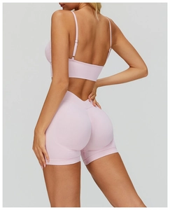 Detailed back view of pink seamless ribbed yoga bra and high-waist fitness shorts