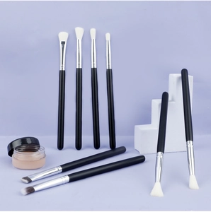Detail of 8 professional eye shadow brushes with wood handles on a purple background