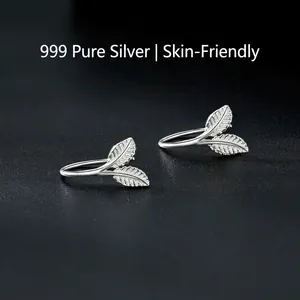 Minimalist S999 sterling silver ginkgo leaf earrings with detailed veins on black background