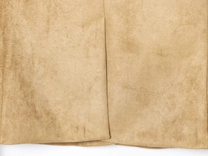 Close-up of tan suede fabric texture and professional stitching on a slim blazer