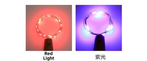 Detail view of red and purple LED wine bottle cork string lights for festive decoration