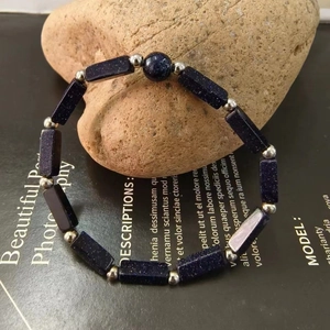 Detail of blue goldstone bracelet with rectangular beads and silver spacers on stone