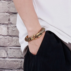 Detailed close-up of a golden dragon head bracelet featuring intricate scale patterns