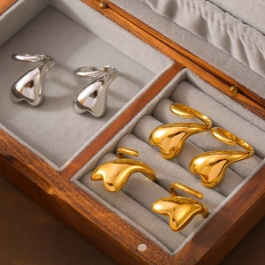 Irregular 18k gold and silver plated titanium steel rings set in a grey jewelry box