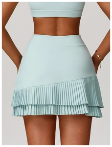 Rear view of light blue high-waisted tennis skirt with asymmetric pleated hem and pocket