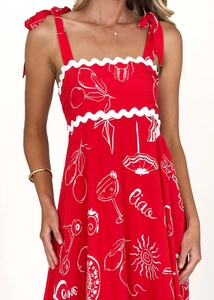 Detail of red floral sundress featuring wavy trim and Ciao Roma lettering print