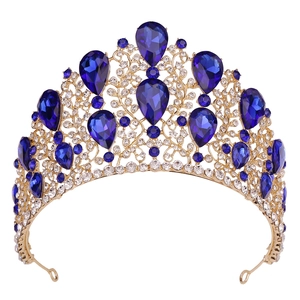 Golden Baroque bridal crown with deep blue teardrop gems and sparkling crystals on white base