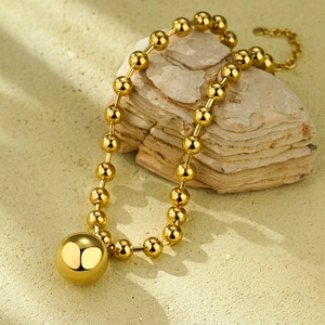 Detailed view of 18K gold ball chain necklace featuring a 2.5cm polished spherical pendant
