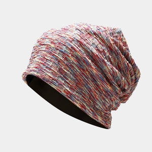 Close-up of the multi-colored knit texture and yarn details on this tie-dye beanie hat