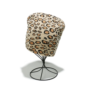 Winter knitted beanie featuring classic leopard print pattern on a beige textured base