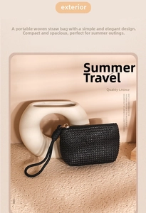 Detail of black woven straw coin purse with thick wrist strap and gold zipper