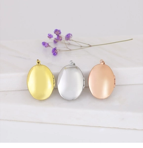 Polished heart locket pendants in gold, silver, and rose gold on a marble surface