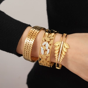 Gold leaf-themed bangle set with tropical hollow patterns and sparkling crystals
