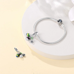 Silver snake chain bracelet with cupcake and whisk charms with enamel accents