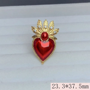 Macro shot of 23.3x37.5mm gold plated heart ring with red wings and zircons