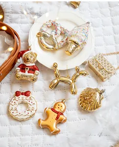 Macro detail of assorted Christmas tree ornaments including teddy bears and balloon dogs