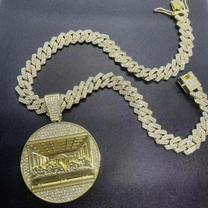 Detail of gold Cuban chain and round pendant featuring The Last Supper relief with crystals