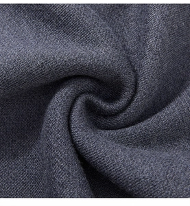 Macro shot of dark grey high-density knitted fabric texture with spiral fold pattern