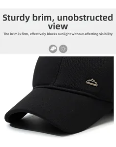 Close-up of a structured black baseball cap with a metal logo and durable twill fabric