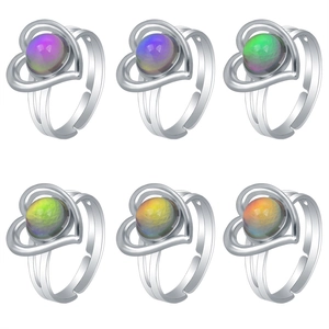 Detail of color-changing gemstone rings in heart frames across six vibrant shades
