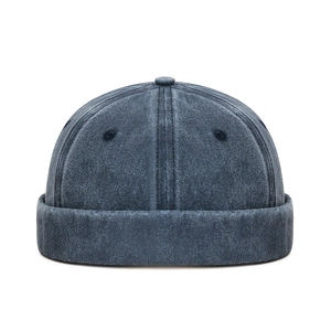 Deep greyish blue washed cotton skull cap with six-panel stitching and rolled brim detail