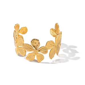 Golden floral open cuff bracelet with radial texture inspired by tropical nature