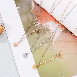 Detailed view of Good Luck round pendants on fine chains in gold, silver and rose gold