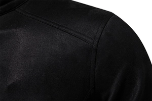 Detailed view of the shoulder stitching and soft suede texture on a black jacket